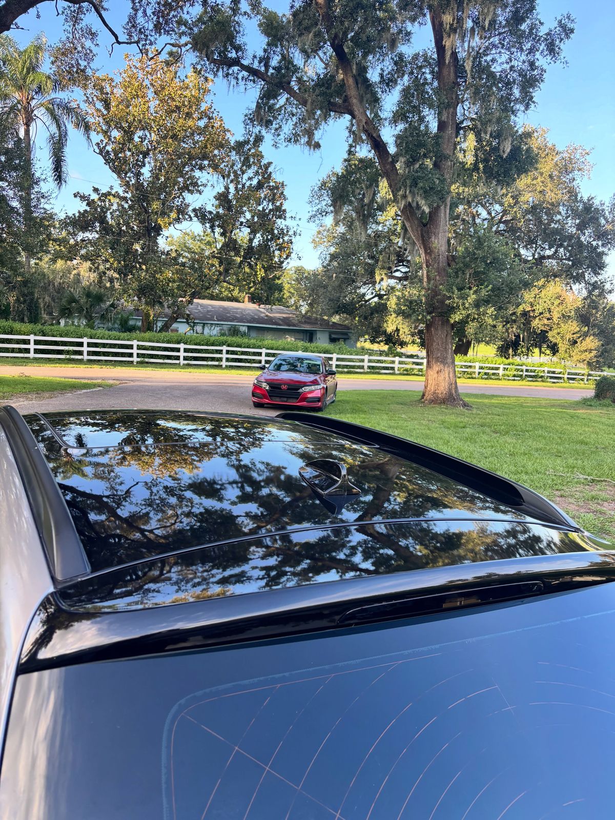 Gloss black roof wrap on a gray sedan