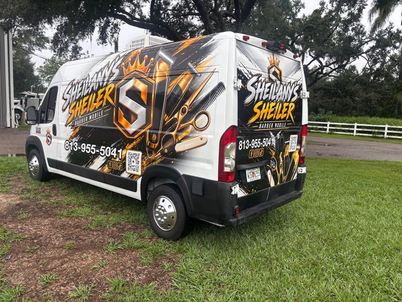White Ram ProMaster van with black and gold printed wrap