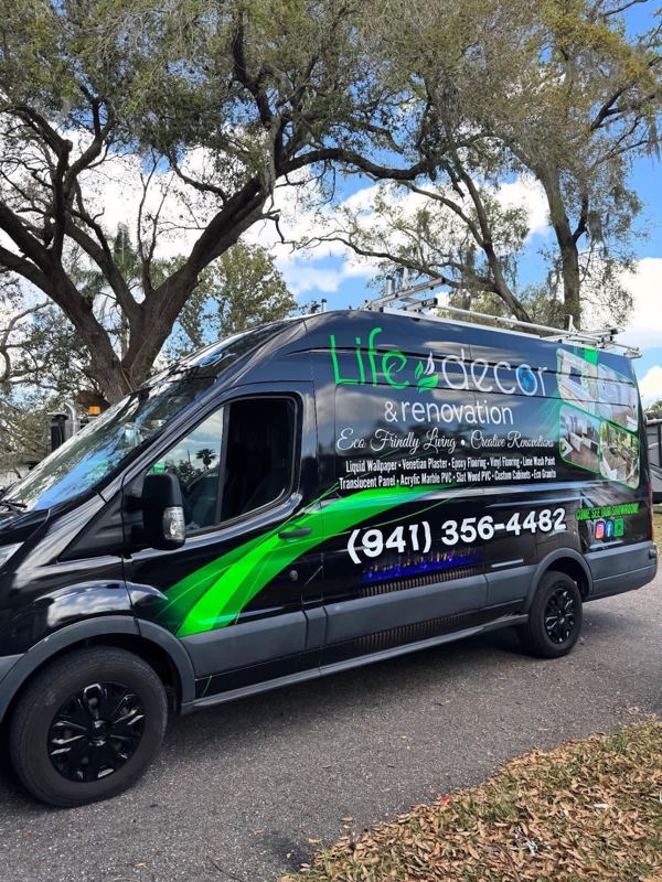 Black Ford Transit van with green home decor company graphics