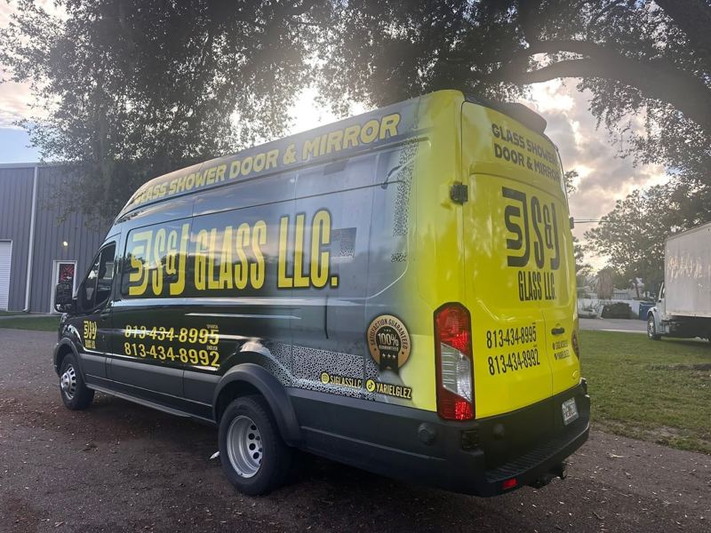 Ford Transit van with a yellow and black company wrap