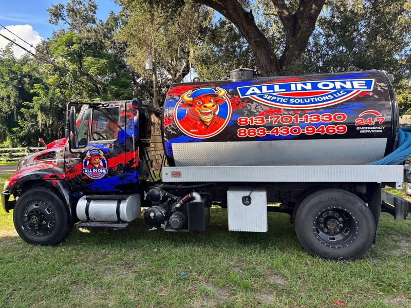 Vacuum tank truck with printed graphics on the tank and cab